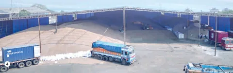 Trucks and cargo containers in a large warehouse yard